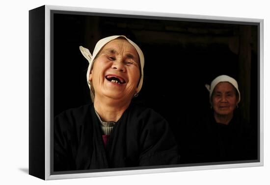 Two Dong Women, One Laughing, in a Dark Room, Sanjiang Dong Village, Guangxi, China-Enrique Lopez-Tapia-Framed Premier Image Canvas