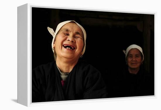 Two Dong Women, One Laughing, in a Dark Room, Sanjiang Dong Village, Guangxi, China-Enrique Lopez-Tapia-Framed Premier Image Canvas