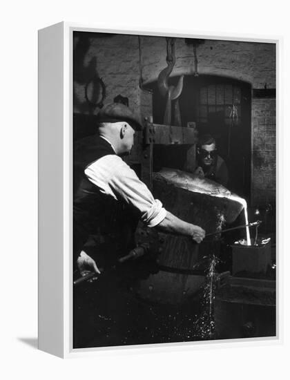 Two Factory Workers Pour Molten Metal into a Small Mould. Photograph by Heinz Zinram-Heinz Zinram-Framed Premier Image Canvas