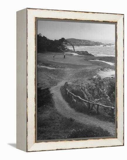 Two Golfers Playing on a Putting Green at Pebble Beach Golf Course-Nina Leen-Framed Premier Image Canvas