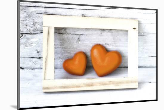 Two Hearts Made of Stone in Picture Frame-Uwe Merkel-Mounted Photographic Print