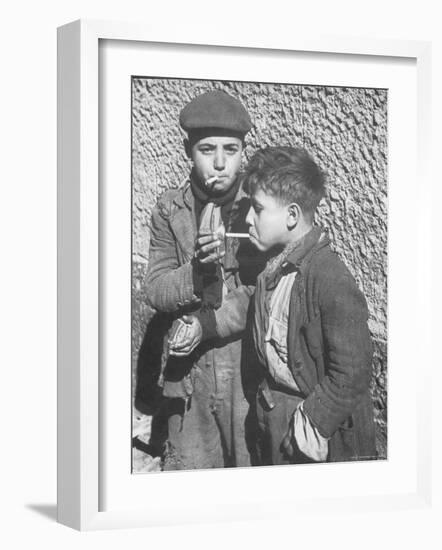 Two Homeless Boys Lighting Up American Cigarettes with British Matches-George Rodger-Framed Photographic Print