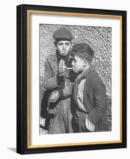 Two Homeless Boys Lighting Up American Cigarettes with British Matches-George Rodger-Framed Photographic Print