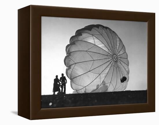 Two Irving Air Chute Co. Employees Struggling to Pull Down One of their Parachutes after Test Jump-Margaret Bourke-White-Framed Premier Image Canvas