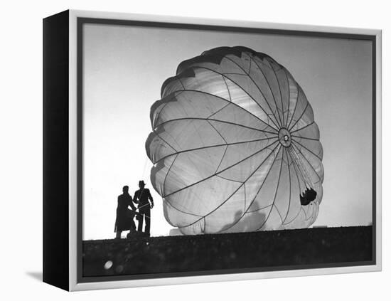 Two Irving Air Chute Co. Employees Struggling to Pull Down One of their Parachutes after Test Jump-Margaret Bourke-White-Framed Premier Image Canvas