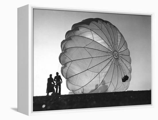 Two Irving Air Chute Co. Employees Struggling to Pull Down One of their Parachutes after Test Jump-Margaret Bourke-White-Framed Premier Image Canvas