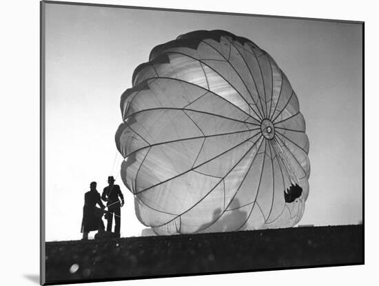 Two Irving Air Chute Co. Employees Struggling to Pull Down One of their Parachutes after Test Jump-Margaret Bourke-White-Mounted Photographic Print