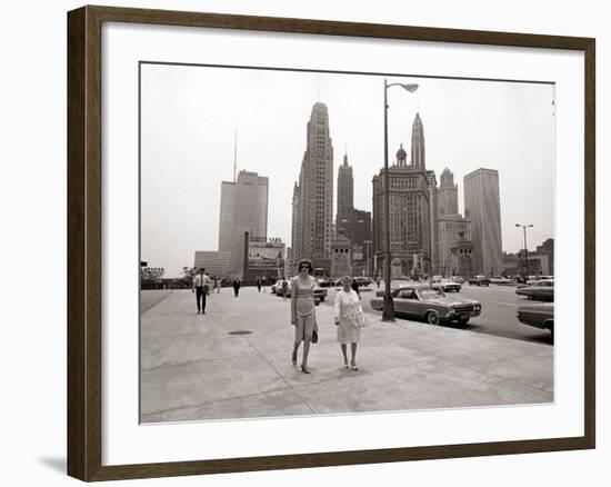 Two Ladies Walking the Sidewalk Skyscrapers in Chicago America's Windy City, in the 1960s-null-Framed Photographic Print