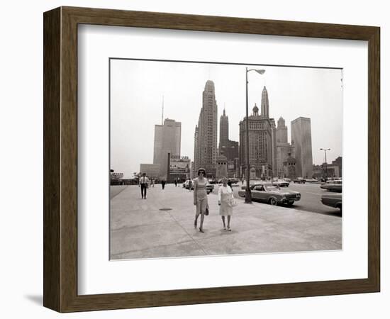 Two Ladies Walking the Sidewalk Skyscrapers in Chicago America's Windy City, in the 1960s-null-Framed Photographic Print