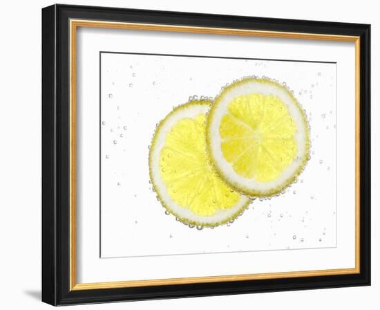 Two Lemon Slices in Water with Air Bubbles-Kröger & Gross-Framed Photographic Print