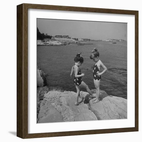 Two Little Girls Modelling Sun Dot Bathing Suits While Playing on the Rocks-Nina Leen-Framed Photographic Print