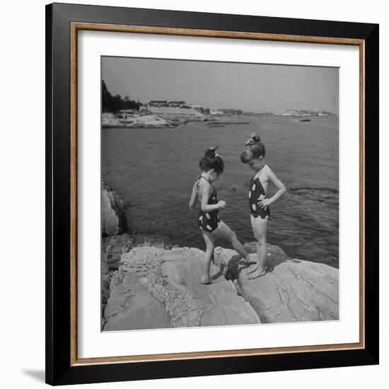 Two Little Girls Modelling Sun Dot Bathing Suits While Playing on the Rocks-Nina Leen-Framed Photographic Print