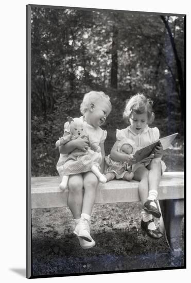 Two Little Girls Sitting on a Bench-Philip Gendreau-Mounted Photographic Print