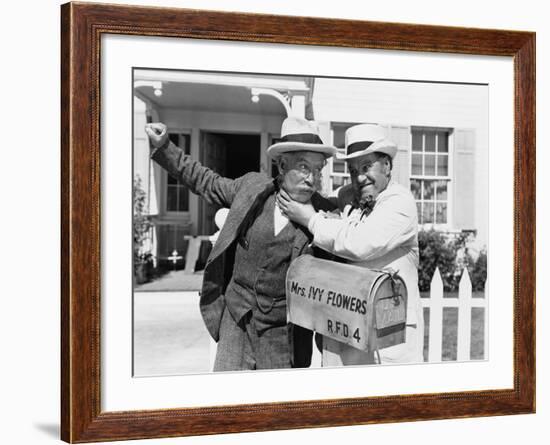 Two Mature Men Fighting Near a Mail Box in Front of a House-null-Framed Photo