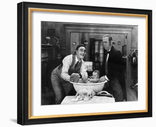 Two Men Giving a Baby a Bath-null-Framed Photo