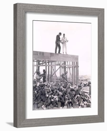 Two Men Going over Blueprints-null-Framed Photo