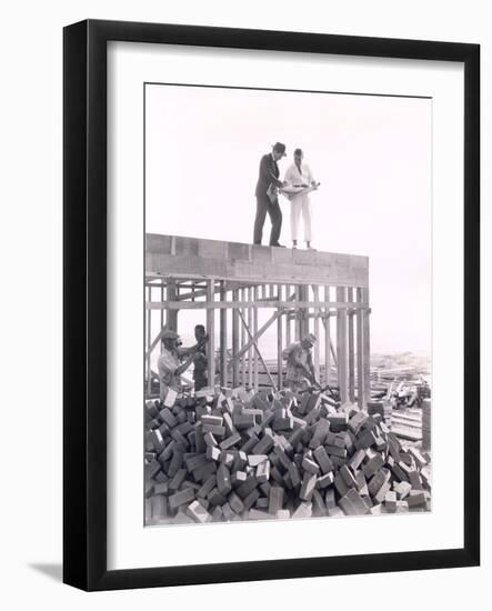 Two Men Going over Blueprints-null-Framed Photo