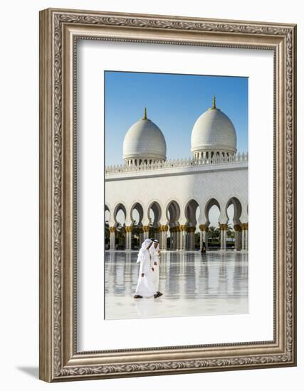 Two Middle Eastern men traditionally dressed walking in the courtyard of the Sheikh Zayed Mosque, A-Stefano Politi Markovina-Framed Photographic Print