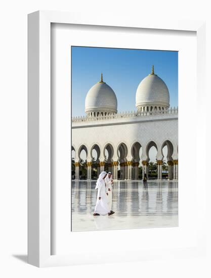 Two Middle Eastern men traditionally dressed walking in the courtyard of the Sheikh Zayed Mosque, A-Stefano Politi Markovina-Framed Photographic Print