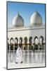 Two Middle Eastern men traditionally dressed walking in the courtyard of the Sheikh Zayed Mosque, A-Stefano Politi Markovina-Mounted Photographic Print