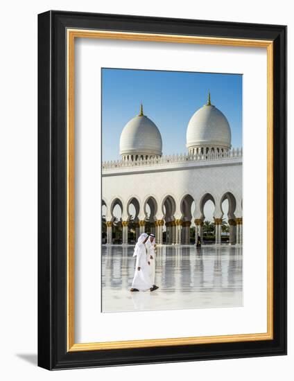 Two Middle Eastern men traditionally dressed walking in the courtyard of the Sheikh Zayed Mosque, A-Stefano Politi Markovina-Framed Photographic Print