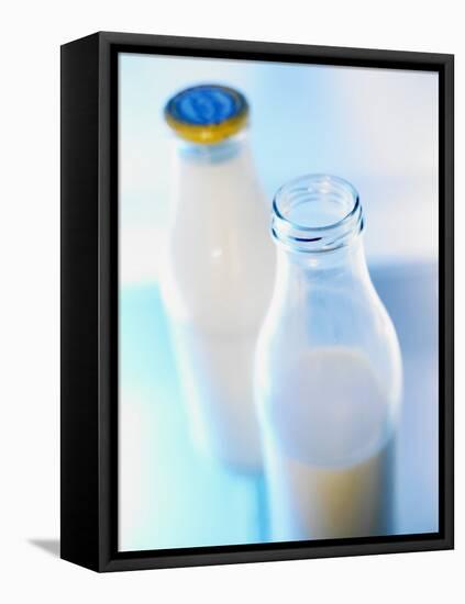 Two Milk Bottles, One Opened-Klaus Arras-Framed Premier Image Canvas