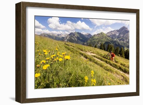 Two Mountain Bikers Riding Through A Flower-Picked Alpine Meadow In Austria-Axel Brunst-Framed Photographic Print
