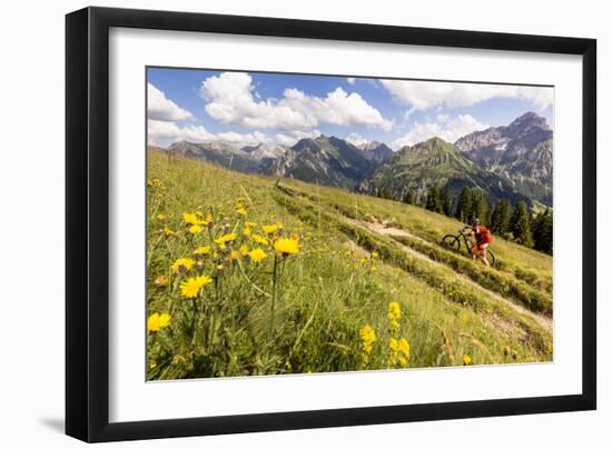 Two Mountain Bikers Riding Through A Flower-Picked Alpine Meadow In Austria-Axel Brunst-Framed Photographic Print