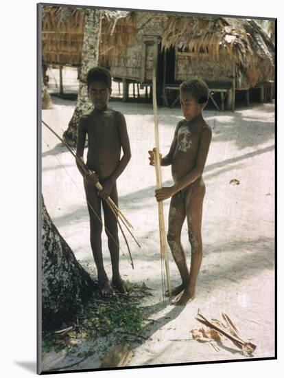 Two Native Male Children with Bows and Arrows Standing on White Beach, Santa Cruz Island-Eliot Elisofon-Mounted Photographic Print