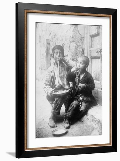 Two Neapolitan Children Slurp Down Spaghetti-null-Framed Art Print