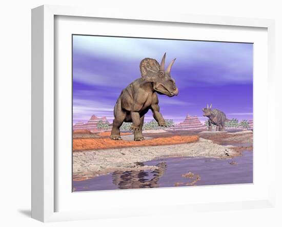 Two Nedoceratops Next to Water in a Colorful Rocky Landscape-null-Framed Art Print