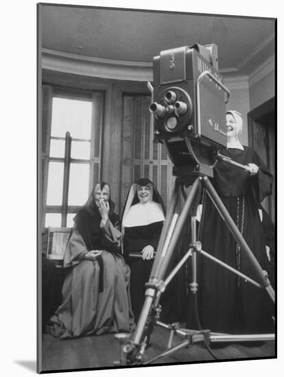Two Nuns Smiling from the Wings While the Third Is Operating the Large TV Camera-null-Mounted Photographic Print