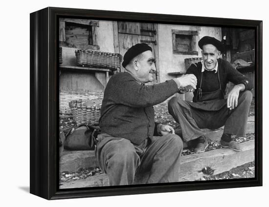 Two Older Basque Men Sitting on a Porch Toasting, as They Prepare to Drink Together-Dmitri Kessel-Framed Premier Image Canvas