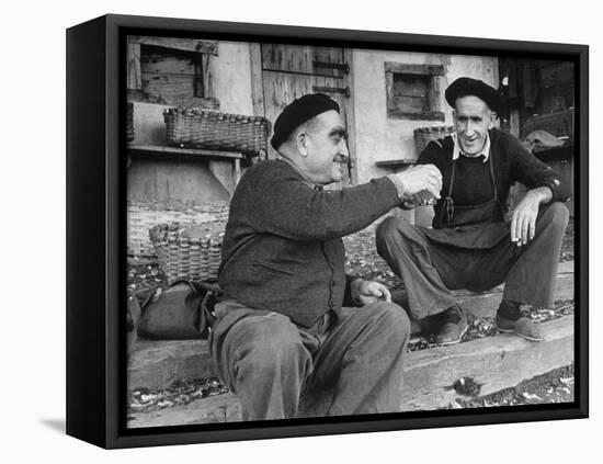 Two Older Basque Men Sitting on a Porch Toasting, as They Prepare to Drink Together-Dmitri Kessel-Framed Premier Image Canvas