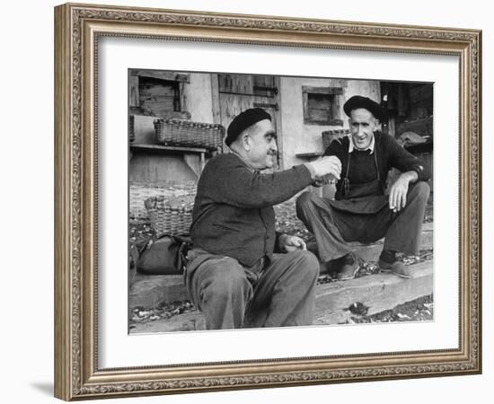 Two Older Basque Men Sitting on a Porch Toasting, as They Prepare to Drink Together-Dmitri Kessel-Framed Photographic Print