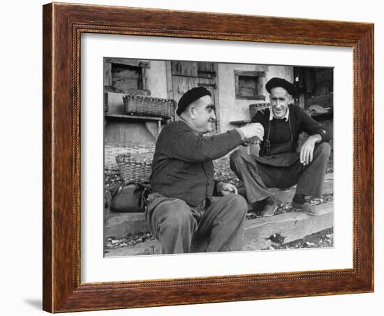 Two Older Basque Men Sitting on a Porch Toasting, as They Prepare to Drink Together-Dmitri Kessel-Framed Photographic Print