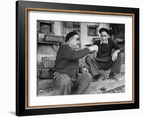 Two Older Basque Men Sitting on a Porch Toasting, as They Prepare to Drink Together-Dmitri Kessel-Framed Photographic Print