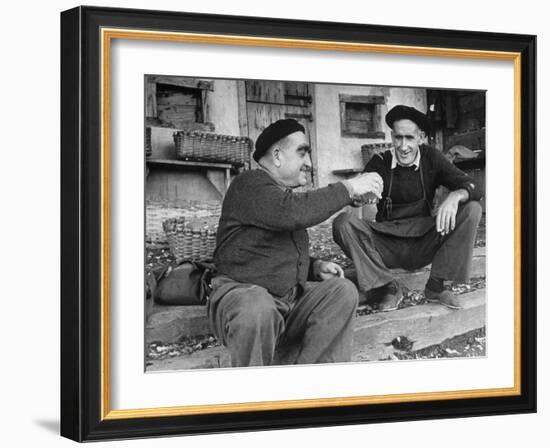 Two Older Basque Men Sitting on a Porch Toasting, as They Prepare to Drink Together-Dmitri Kessel-Framed Photographic Print