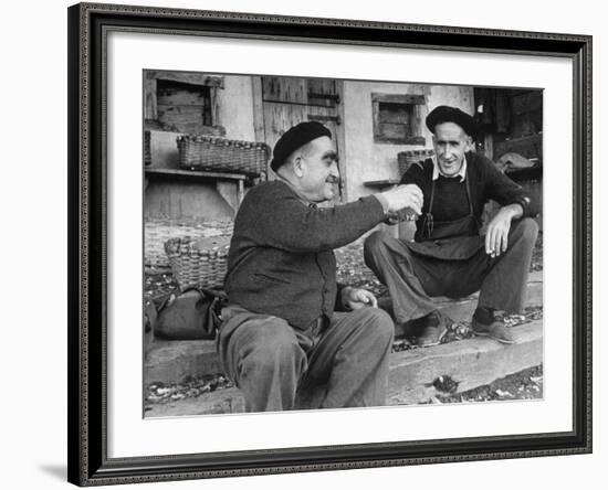 Two Older Basque Men Sitting on a Porch Toasting, as They Prepare to Drink Together-Dmitri Kessel-Framed Photographic Print