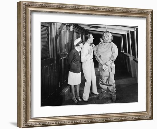 Two People Looking in Shock at a Diver in a Divers Suit-null-Framed Photo