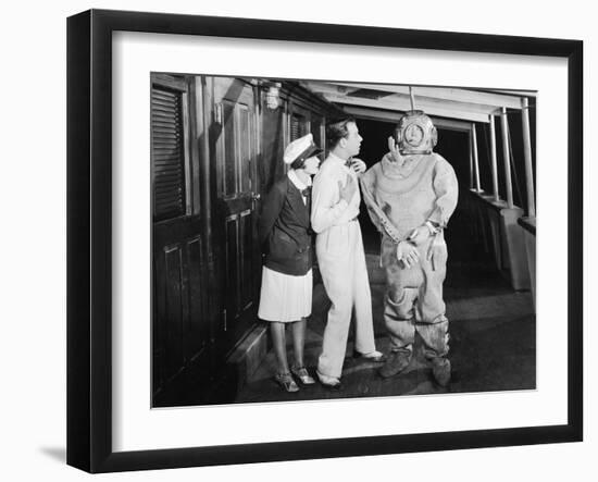 Two People Looking in Shock at a Diver in a Divers Suit-null-Framed Photo