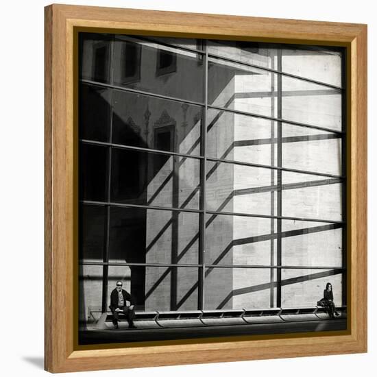 Two People Sitting Outside a Modern Glass Building-Eudald Castells-Framed Premier Image Canvas