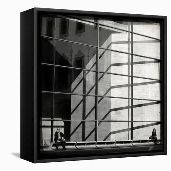 Two People Sitting Outside a Modern Glass Building-Eudald Castells-Framed Premier Image Canvas