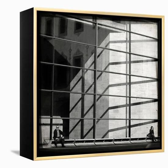 Two People Sitting Outside a Modern Glass Building-Eudald Castells-Framed Premier Image Canvas
