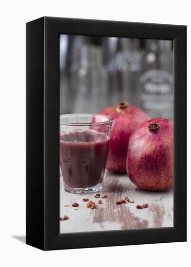 Two Pomegranates and Glass with Pomegranate Juice, Close-Up-Jana Ihle-Framed Premier Image Canvas