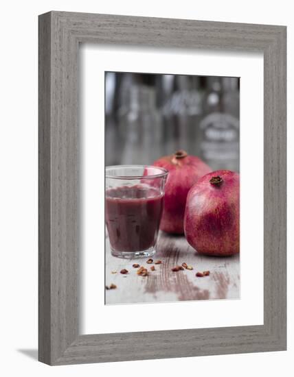 Two Pomegranates and Glass with Pomegranate Juice, Close-Up-Jana Ihle-Framed Photographic Print