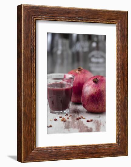 Two Pomegranates and Glass with Pomegranate Juice, Close-Up-Jana Ihle-Framed Photographic Print