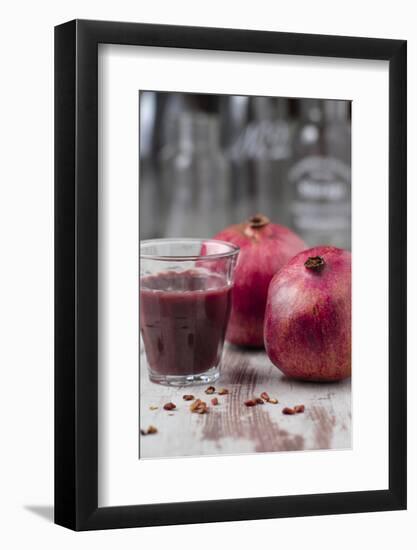 Two Pomegranates and Glass with Pomegranate Juice, Close-Up-Jana Ihle-Framed Photographic Print