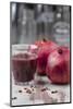 Two Pomegranates and Glass with Pomegranate Juice, Close-Up-Jana Ihle-Mounted Photographic Print