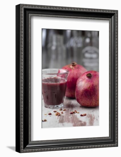 Two Pomegranates and Glass with Pomegranate Juice, Close-Up-Jana Ihle-Framed Photographic Print